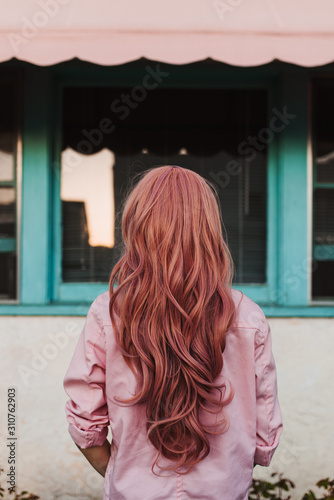 Back view of woman's beautiful pink wig photo