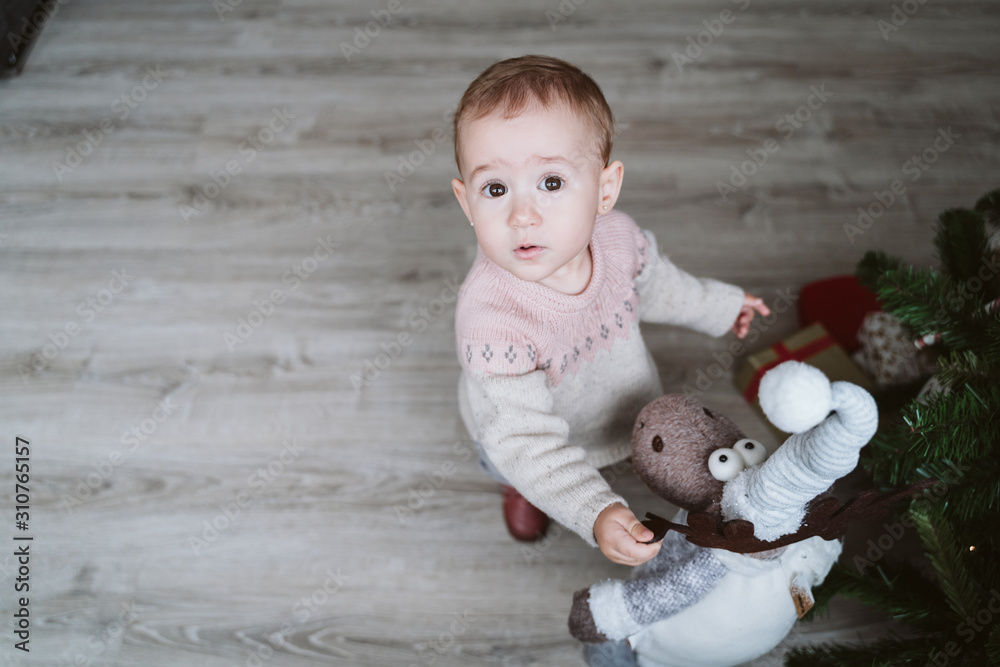 happy baby girl decorating the Christmas tree happy baby girl decorating the Christmas tree