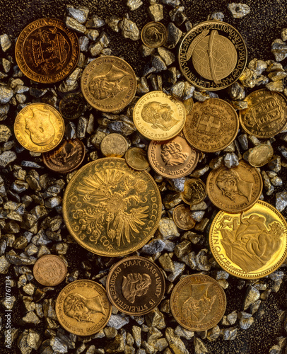 A beautiful layout of vintage gold coins lying on gold and silver chips