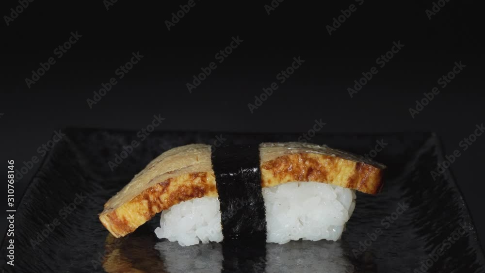 Putting Japanese Egg Sushi on Plate with Chopsticks Putting Japanese Egg Sushi on Plate with Chopsticks