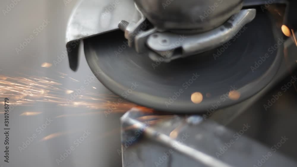 Grinding metal with a circular saw. Processing a metal structure with a