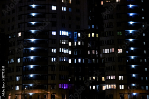 light in the windows at night in an apartment building