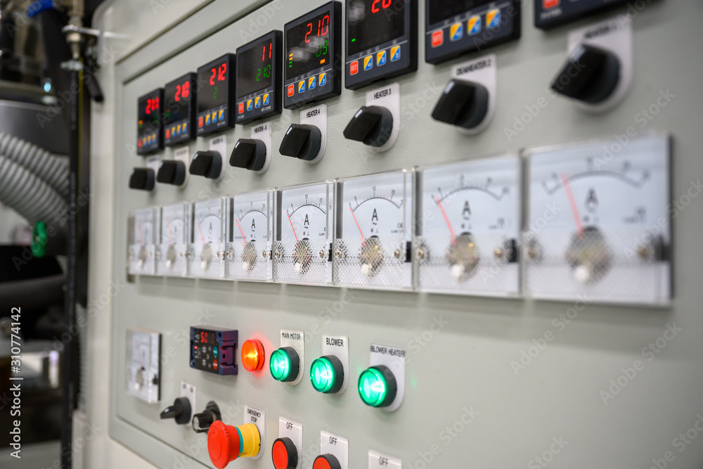 Electrical control panel and digital temperature control of plastic film making machine to produce bags.