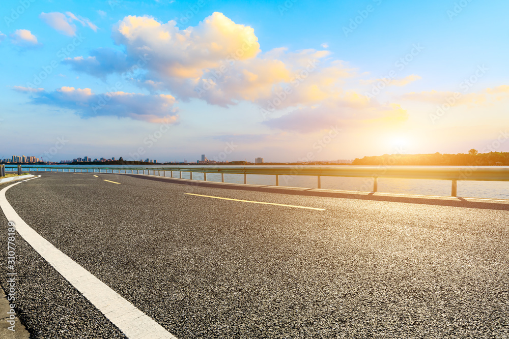 Asphalt road and Suzhou city skyline with beautiful clouds at sunset. Asphalt road and Suzhou city skyline with beautiful clouds at sunset.