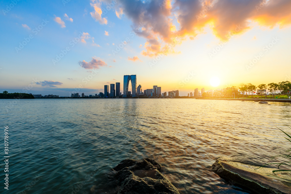 Naklejka premium Suzhou city skyline and water reflection at sunset.