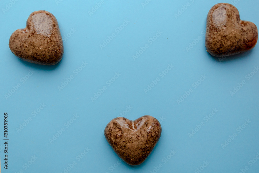Valentine's flat lay with love chocolate gingerbread heart on colorful blue background, greeting card copy space top view. The celebration of Valentine's Day. Valentine's flat lay with love chocolate gingerbread heart on colorful blue background, greeting card copy space top view. The celebration of Valentine's Day.