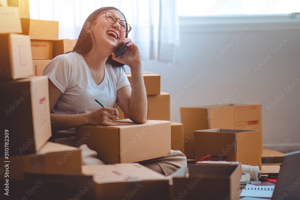Selling products online. Portrait of a pretty woman phone talking to clients for shipping. Selling products online. Portrait of a pretty woman phone talking to clients for shipping.