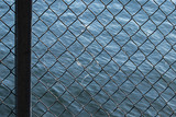 a chain link fence in front of water