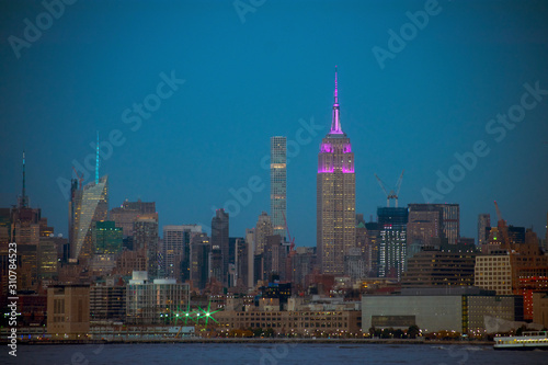 A night view of NYC s midtown Manhattan skyline  including the Empire Stete Building  from across the Hudson River  at Liberty State Park  New Jersey