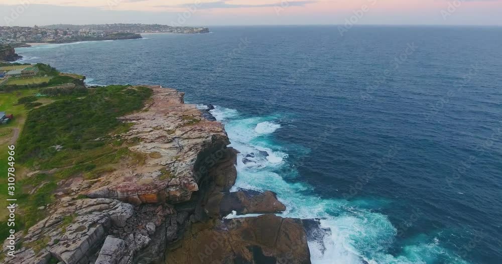 The Stunning Scenery Of Clovelly, England With Waves Crashing On The Rocky Bottom - Aerial Shot The Stunning Scenery Of Clovelly, England With Waves Crashing On The Rocky Bottom - Aerial Shot