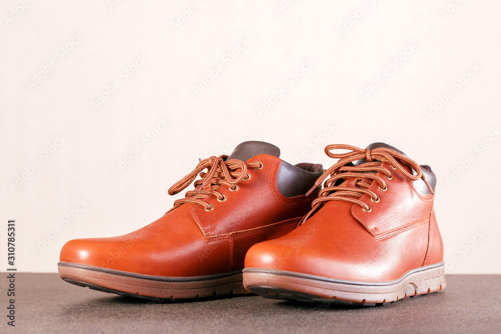 Modern elegance men's boots shoes on floor with place for text.