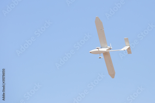White glider plane in blue sky