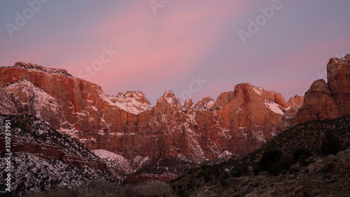 Cliffs in Zion lit up during colorful sunrise.
