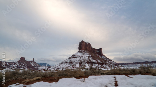 Parriott Mesa in winter at sunset with clouds through the sky during sunset.