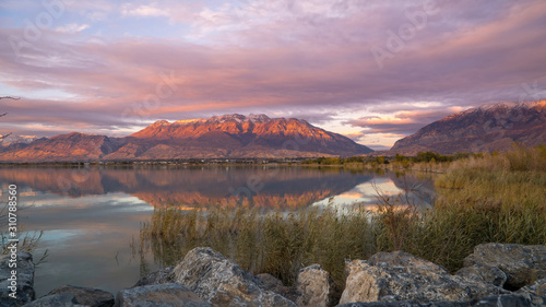 Mountain reflection during colorful sunset looking at Timpanogos mountain from across Utah Lake.
