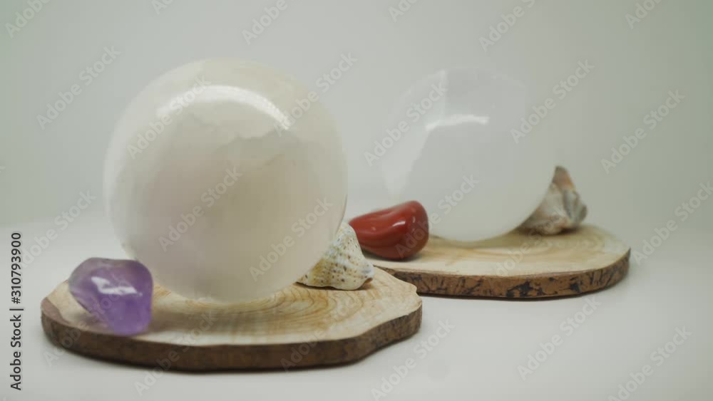 Precious White Crystal Balls On Top Of A Wood With Sea Shells And Gem Stones - Close Up Shot Precious White Crystal Balls On Top Of A Wood With Sea Shells And Gem Stones - Close Up Shot