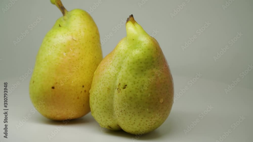 Two Delicious Freshly Picked Pear Rotating Clockwise On The Table - Close Up Shot Two Delicious Freshly Picked Pear Rotating Clockwise On The Table - Close Up Shot