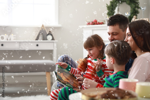 Happy family reading book a...