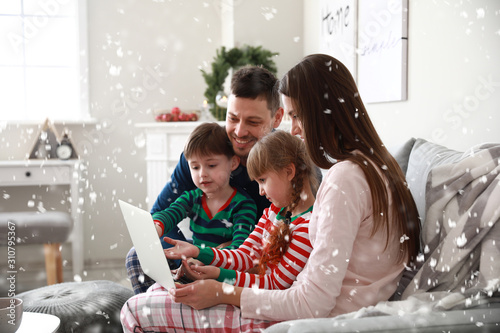 Happy family with laptop re...