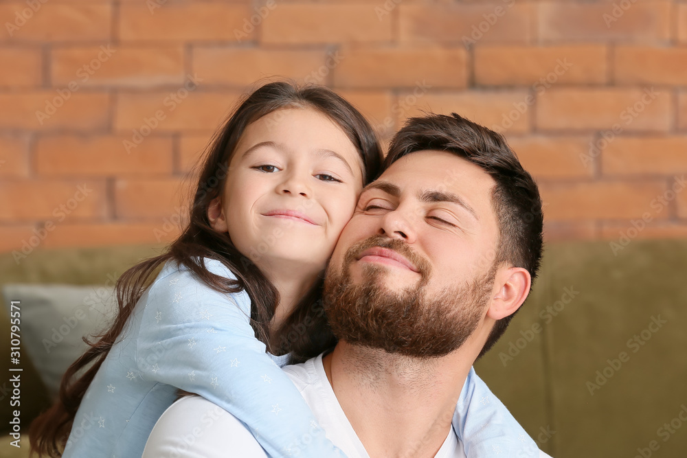 Portrait of father with little daughter at home