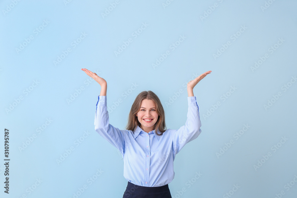 Fototapeta premium Young businesswoman on color background