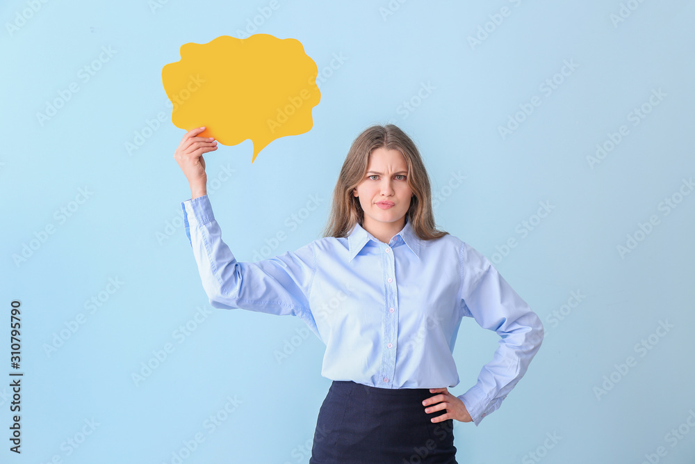 Young confused businesswoman with blank speech bubble on color background Young confused businesswoman with blank speech bubble on color background