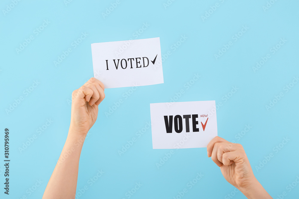 Hands of voting people with paper sheets on color background Hands of voting people with paper sheets on color background