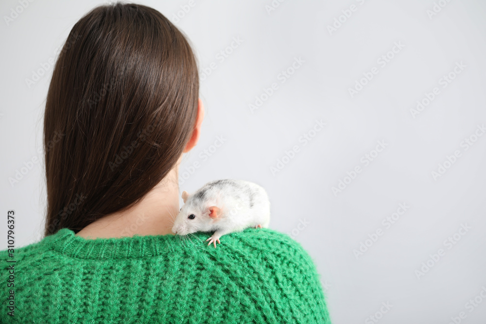 Young woman with cute rat on white background, back view Young woman with cute rat on white background, back view