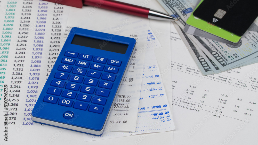 Payment card and calculator on top of supermarket receipt. Shopping and payment concept Payment card and calculator on top of supermarket receipt. Shopping and payment concept
