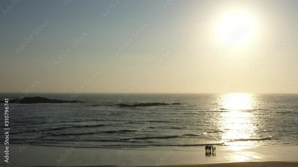 Aerial jib shot over sand dunes reveals sunrise over beach and ocean Aerial jib shot over sand dunes reveals sunrise over beach and ocean