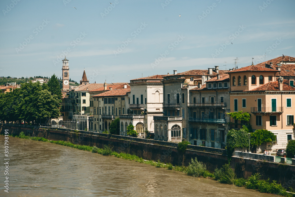 View of traditional residential buildings along the river promenade in Verona in Italy