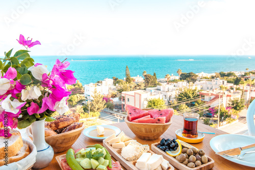 Fototapeta Naklejka Na Ścianę i Meble -  Breakfast on the beach at hotel or resort by the sea in summer season. Holiday and vacation breakfast image.Traditional Turkish or Greek breakfast at bodrum town beach in Turkey or Greece
