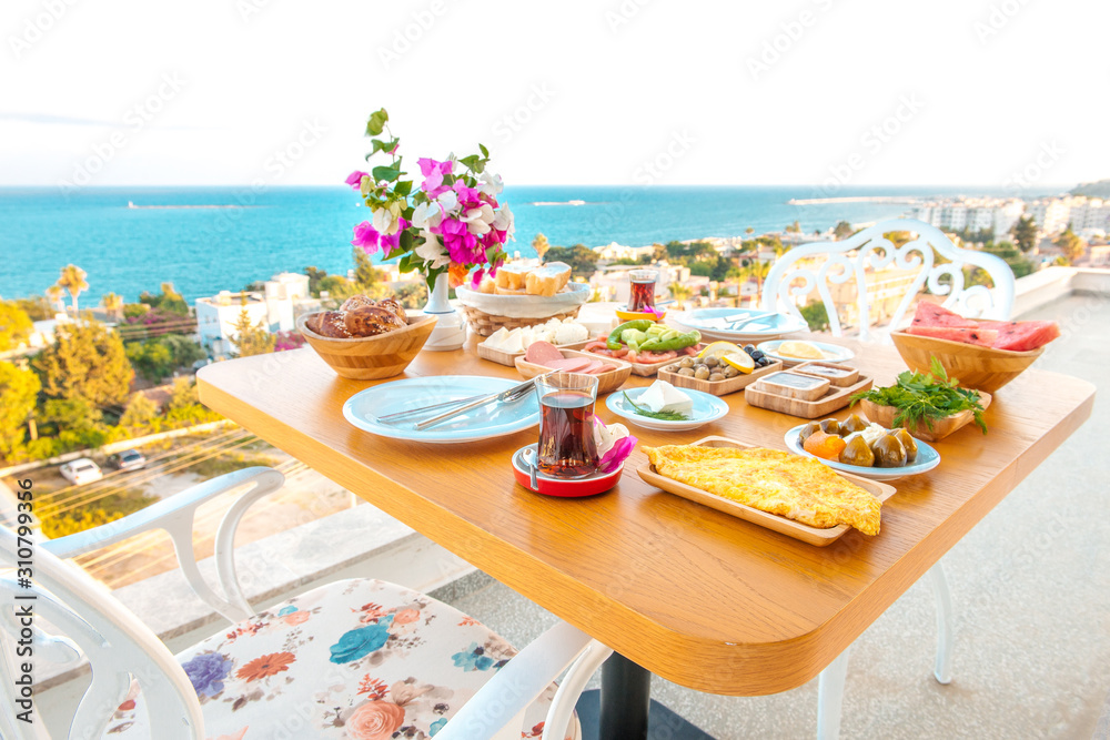 Fototapeta premium Breakfast on the beach at hotel or resort by the sea in summer season. Holiday and vacation breakfast image.Traditional Turkish or Greek breakfast at bodrum town beach in Turkey or Greece