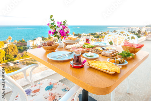 Breakfast on the beach at hotel or resort by the sea in summer season. Holiday and vacation breakfast image.Traditional Turkish or Greek breakfast at bodrum town beach in Turkey or Greece