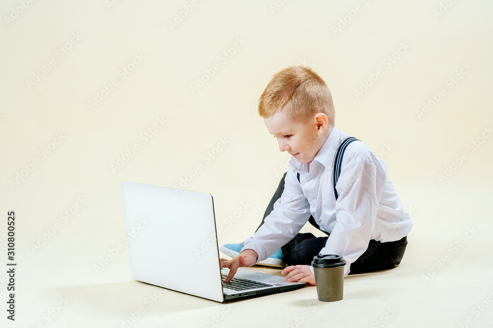 little red-haired boy in a business suit with a phone in his hand hurries to a meeting in a business suit, business, mini boss little red-haired boy in a business suit with a phone in his hand hurries to a meeting in a business suit, business, mini boss