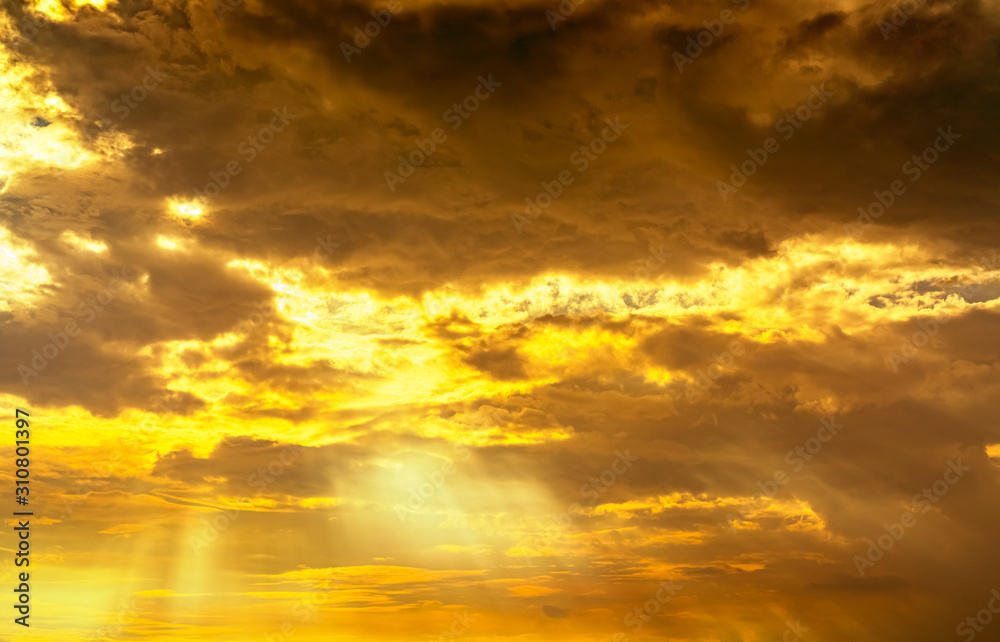 God light. Dramatic golden cloudy sky with sun beam. Yellow sun rays through  golden clouds. God light from heaven for hope and faithful concept. Believe in god. Beautiful sunlight sky background.