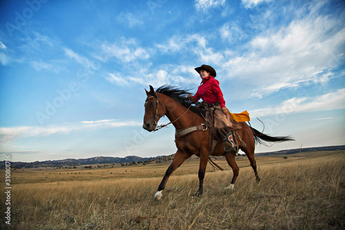 Cowgirl on Running Horse