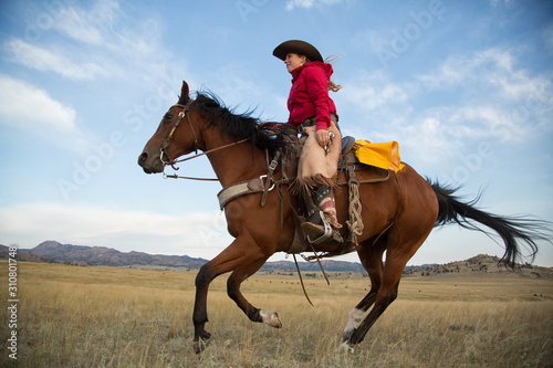 Cowgirl on Running Horse