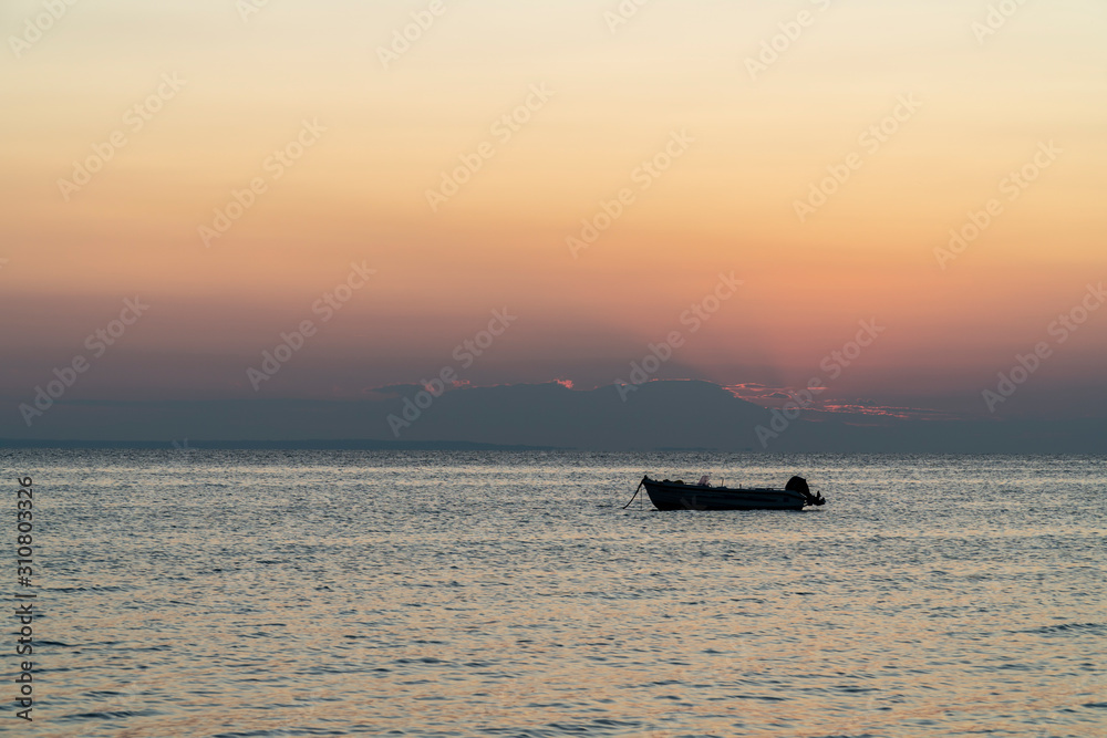 Boat in the middle of the sea during sunset
