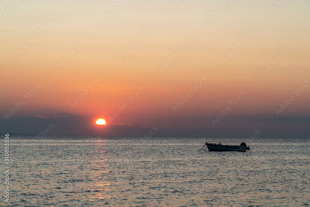 Boat in the middle of the sea during sunset