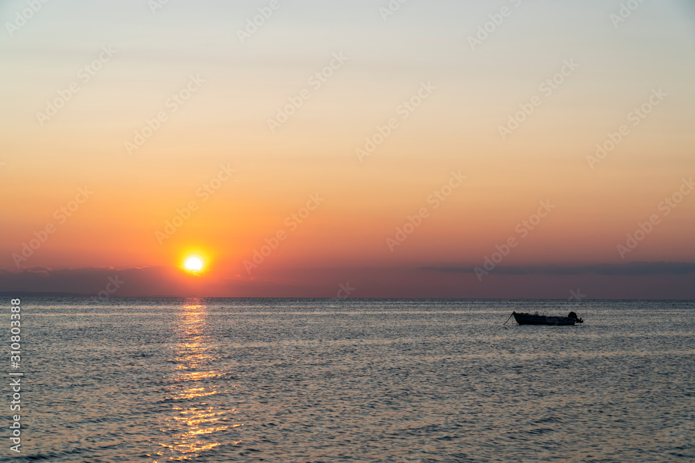 Boat in the middle of the sea during sunset