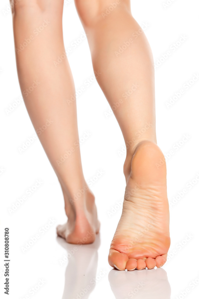 Beautifully groomed female feet on a white background Beautifully groomed female feet on a white background