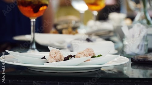 Slow motion shot showing an appetizer plate at a fancy formal dining event