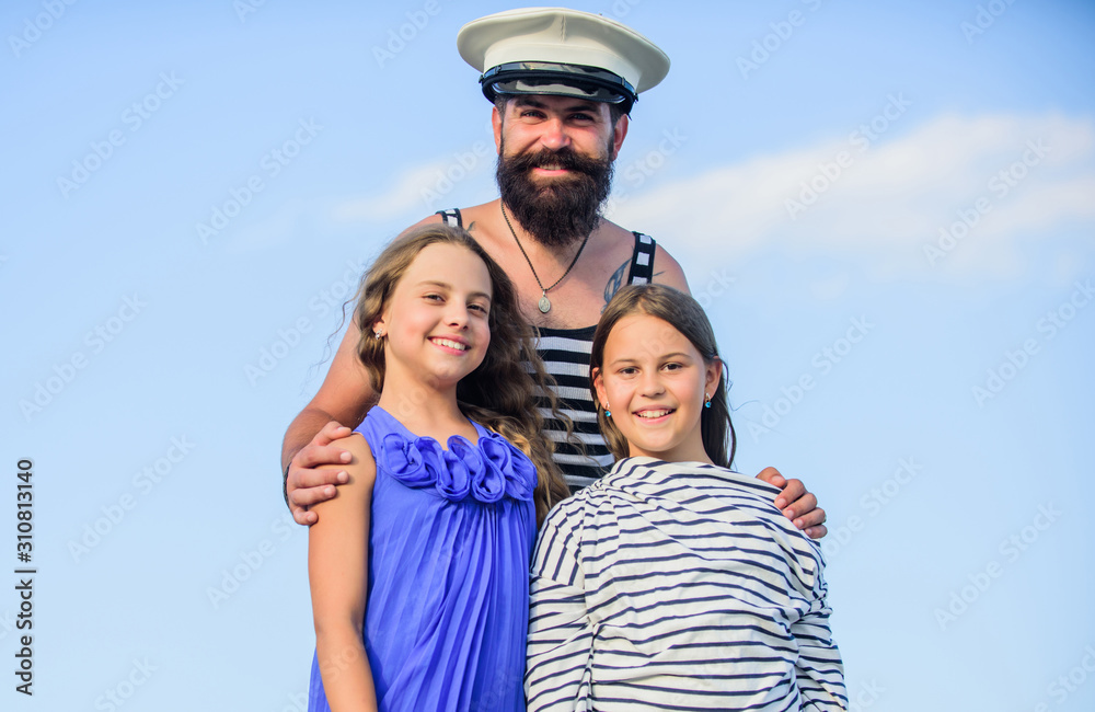 Dad sailor and daughters outdoors. Captain welcome on board. Marine tour. Sea cruise. Handsome bearded sailor with kids. Travel around world. Travel by sea. Summer travel concept. Happy family