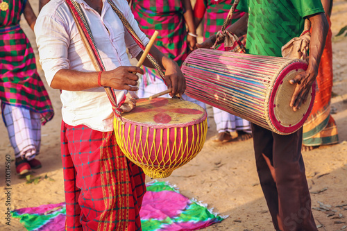 Tribal men playing local musical instruments at a folk dance at Bolpur, Shantiniketan, West Bengal
