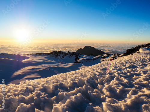 hikers on the ridge ascend mount kilimanjaro the tallest peak in africa.