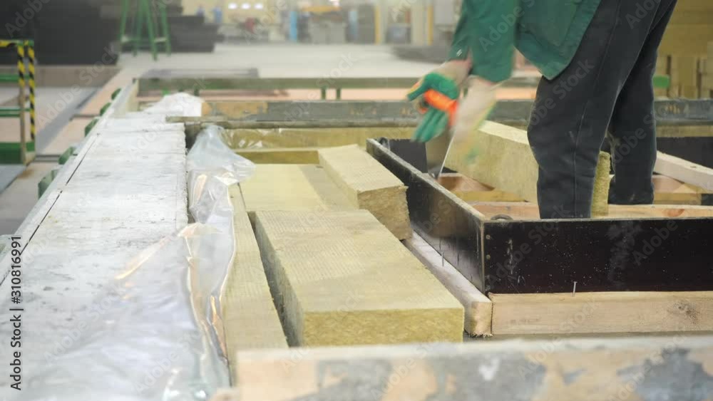 Install thermal insulation in concrete sandwich panel. Workers in the workshop of the House-building plant. Concrete plant. Install thermal insulation in concrete sandwich panel. Workers in the workshop of the House-building plant. Concrete plant.