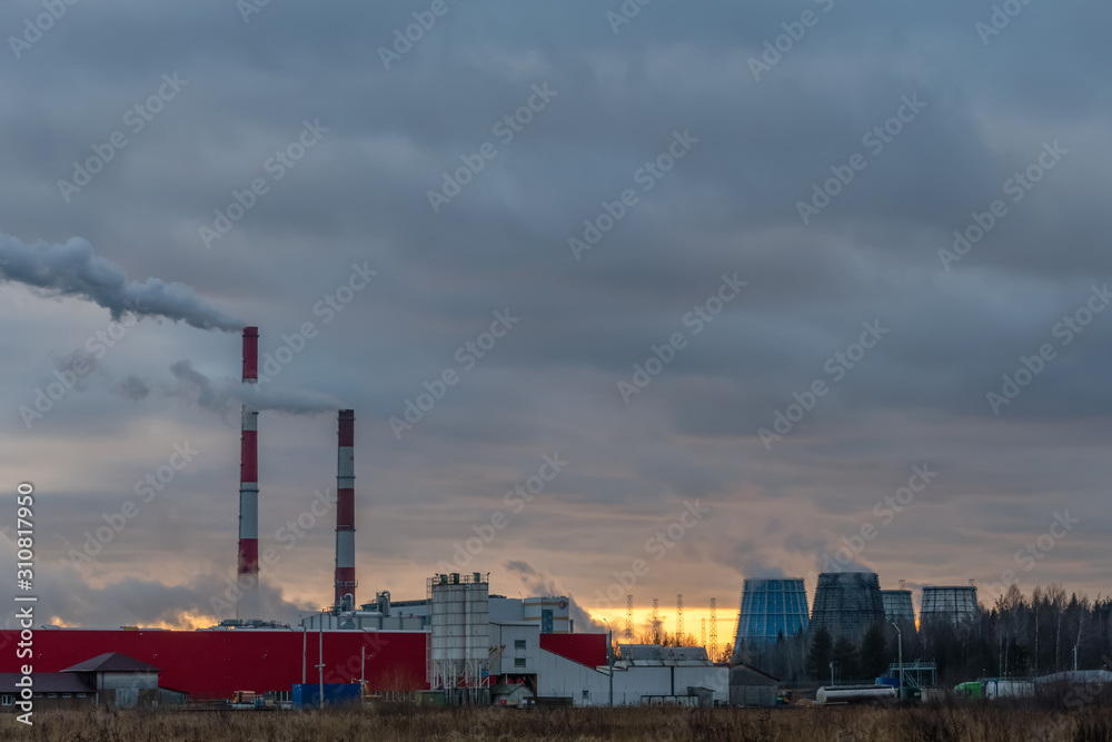Smoking factory chimneys against the sunset. Environmental pollution