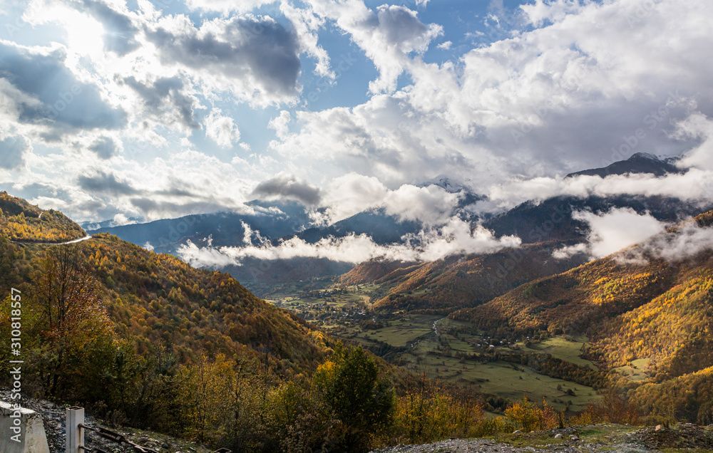 Mountain  slopes covered with forests and low thunderclouds in Svaneti in the mountainous part of Georgia