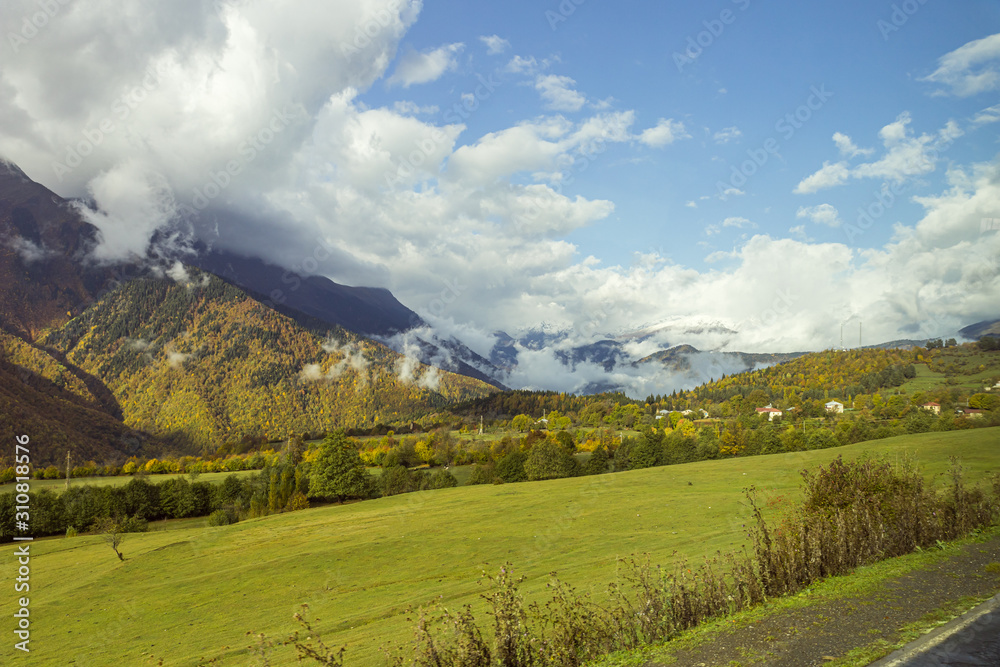 Obraz premium Mountain slopes covered with forests and low thunderclouds in Svaneti in the mountainous part of Georgia
